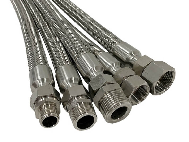 Many flexible braided metal hoses are displayed.
