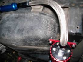 Flexible metal hose in under-hood environment is installed without any sharp bend.